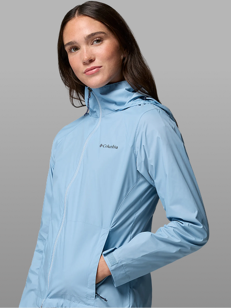 A woman wearing a light blue rain jacket.