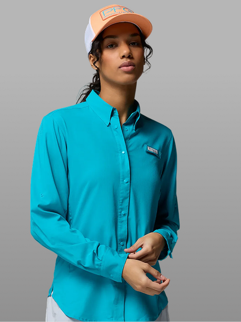 A woman wearing a bright blue long-sleeve button-up.