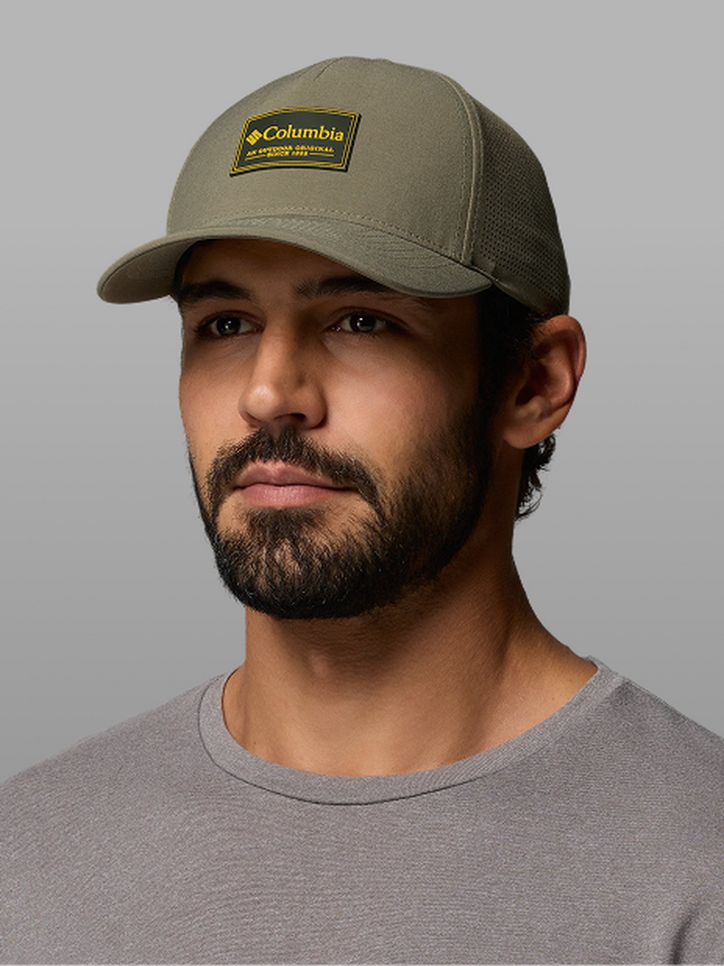 A man wearing a green ball cap.