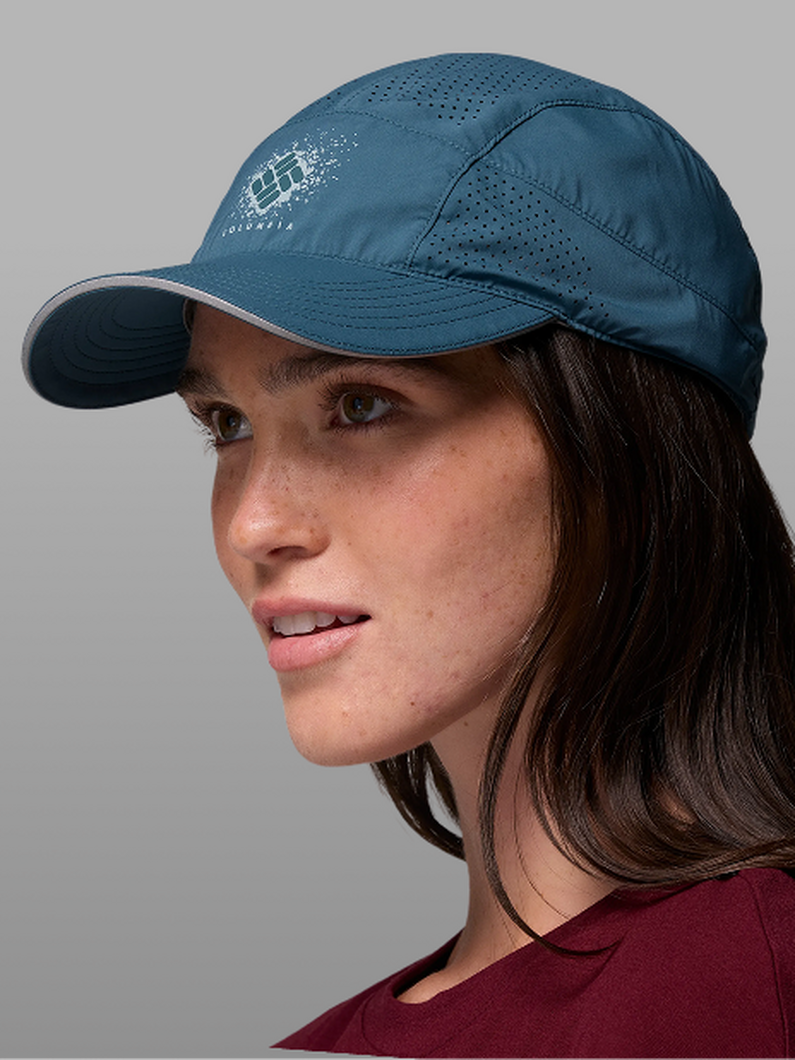 A woman wearing a blue baseball cap.