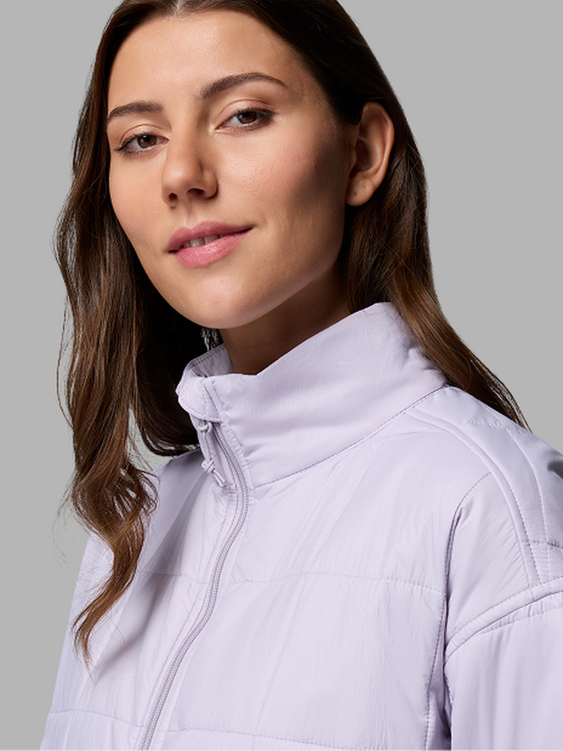 A woman wearing a purple jacket.