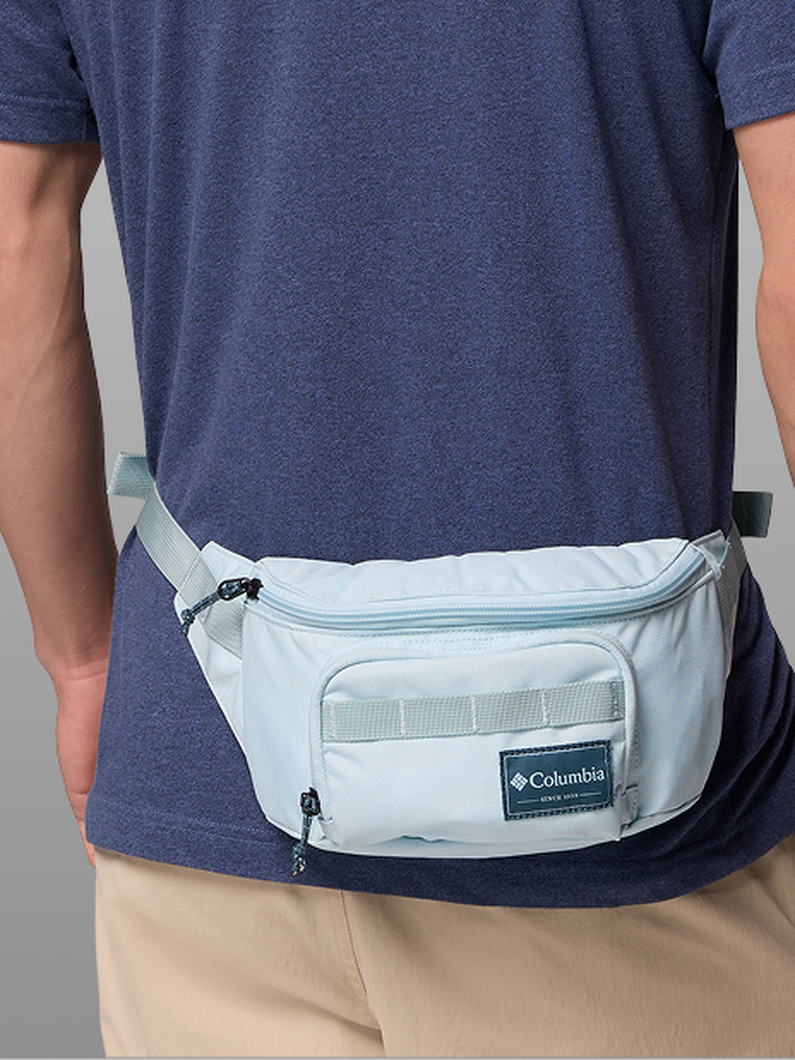 A man wearing a blue hip pack.