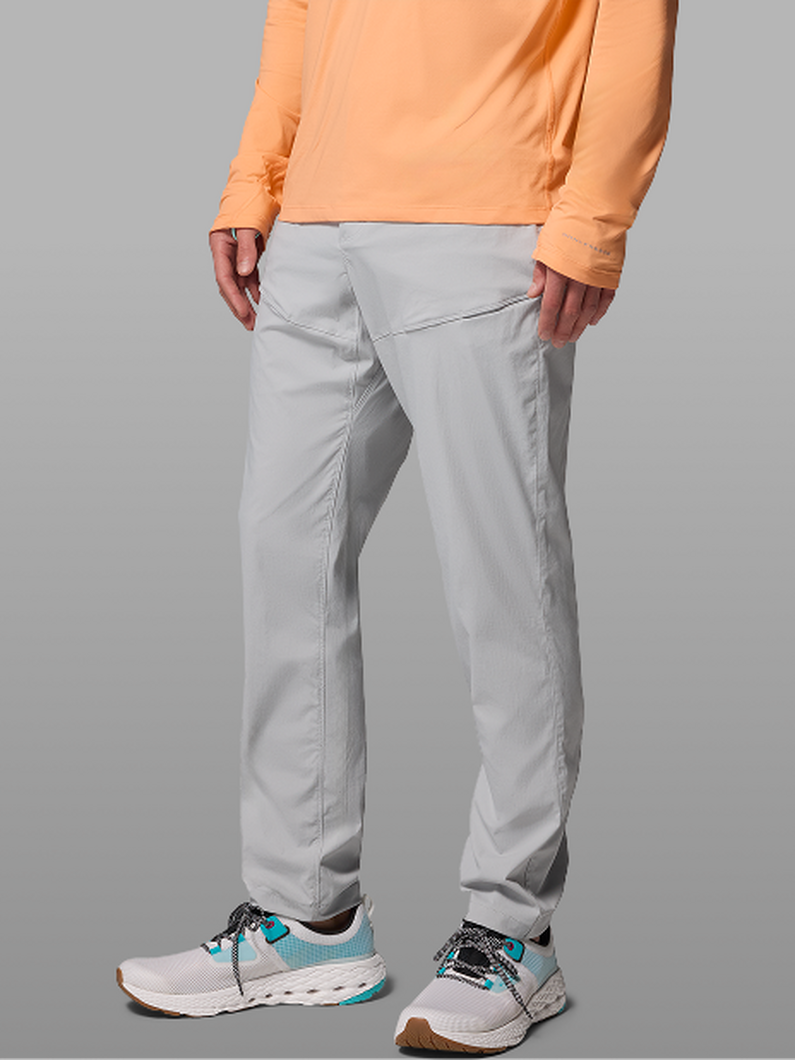 Waist-down image of a man wearing grey pants and sneakers.