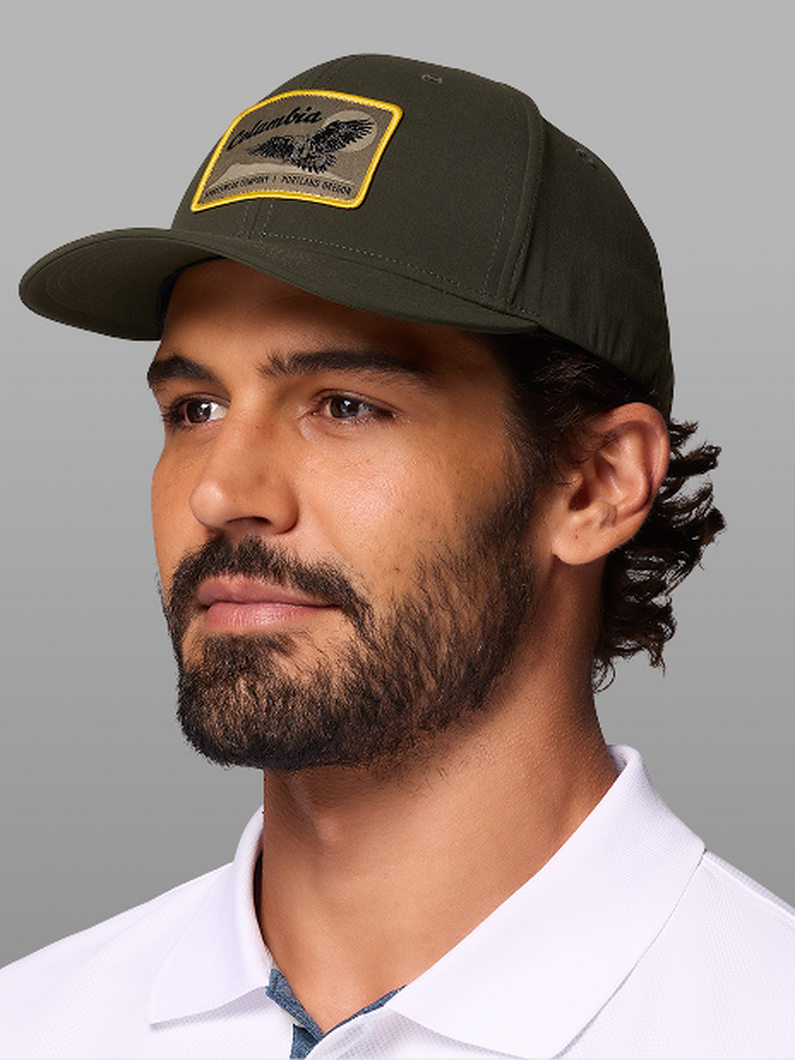 A man wearing a green baseball cap.