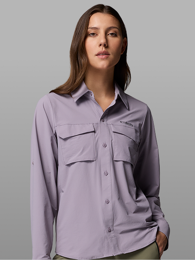 A woman wearing a purple button-up shirt.
