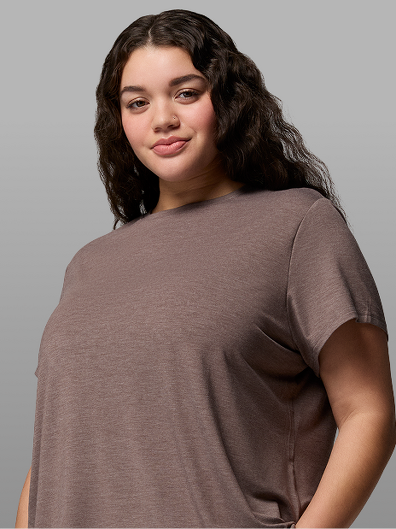 A woman wearing a brown short-sleeve shirt.