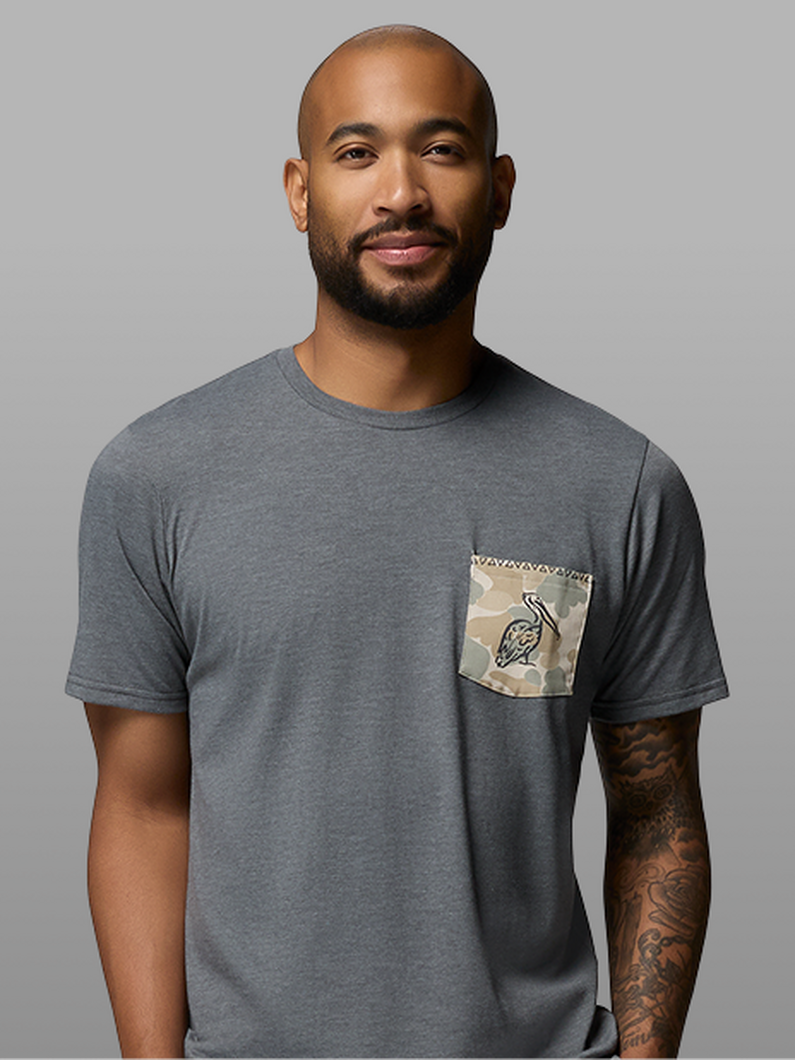 A man wearing a grey short-sleeve shirt.