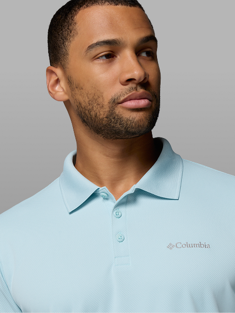 A man wearing a light blue polo.