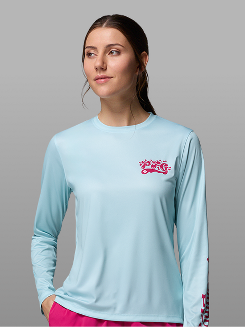 A woman wearing a blue long-sleeve PFG shirt.