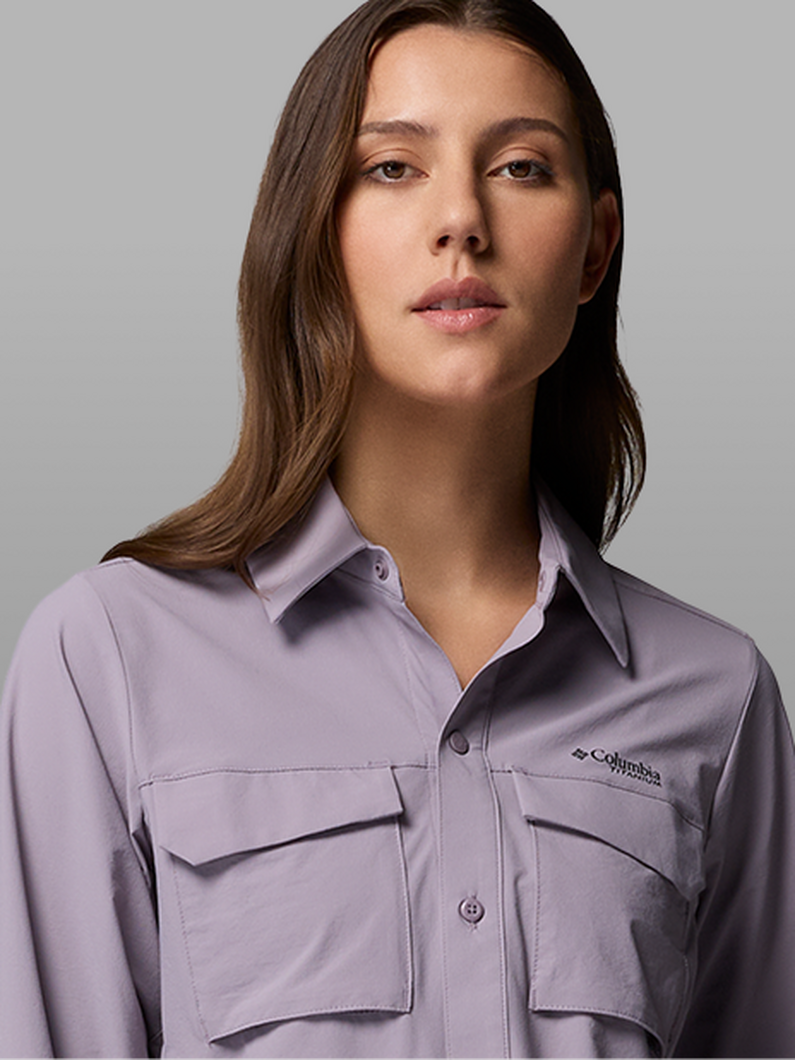 A woman wearing a purple button-up.