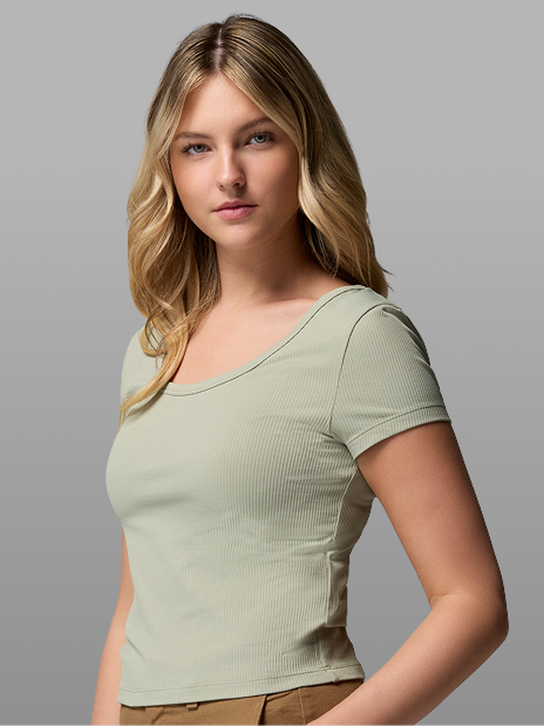 A woman wearing a light green short-sleeve shirt.