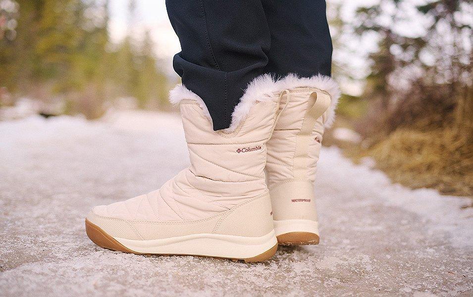 A woman stands outside with feet that are toasty warm thanks to a pair of Columbia Sportswear winter boots.