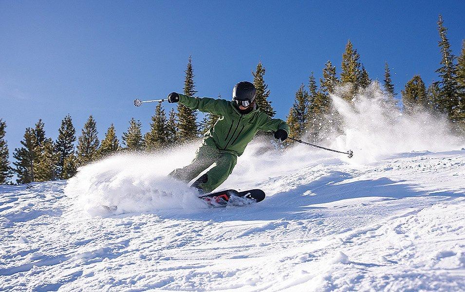 A young skier makes a smooth turn on a perfect bluebird day. 