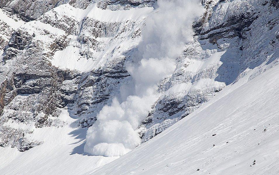 A large avalanche roars down a low angle cliff band. Fortunately, there are no people in its tracks.