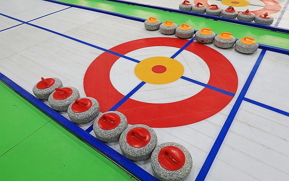Everyone is ready to start curling as the stones are neatly lined up on either side of the Button--the curling target--and ready for play. 
