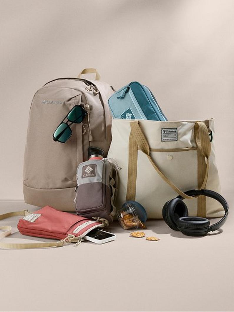Assortment of bags and accessories including backpacks, tote bag, wallet, headphones, and water bottle.