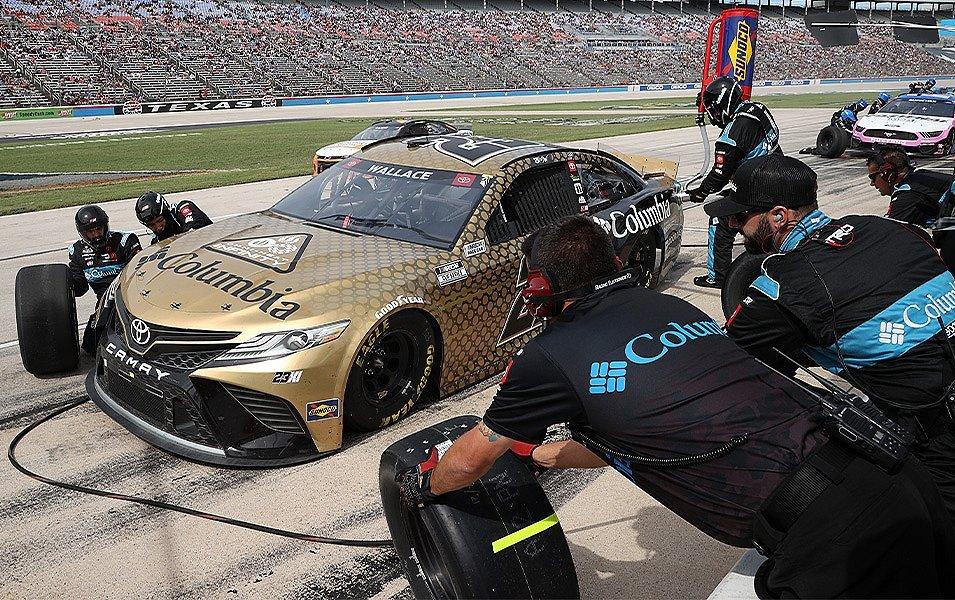 Bubba’s highly efficient Pit Crew, wearing Columbia Sportswear logos on their shirts, change the tires on the Columbia-wrapped car. 

 