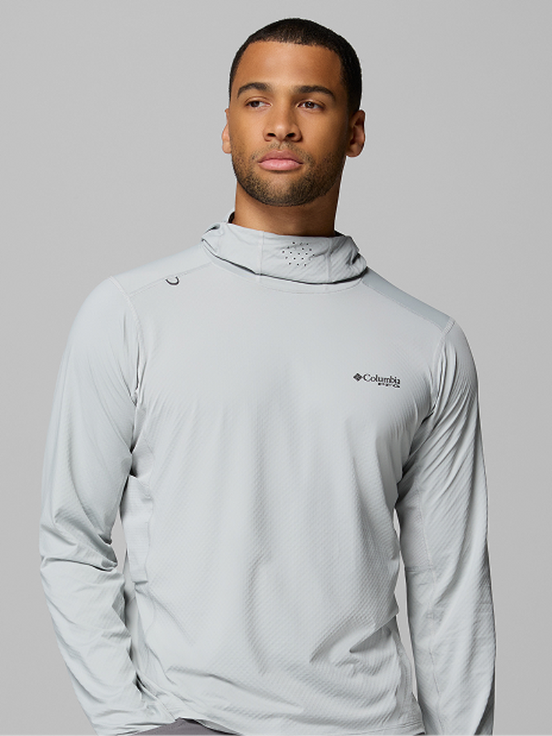 Man wearing light gray long-sleeve performance shirt with integrated face covering hood.
