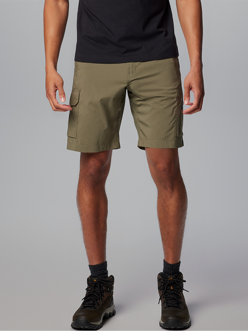 Man wearing olive green cargo shorts with multiple pockets and black hiking boots.