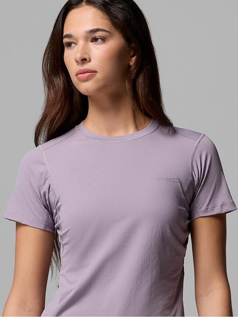 Woman wearing a lilac crew neck short-sleeve t-shirt.