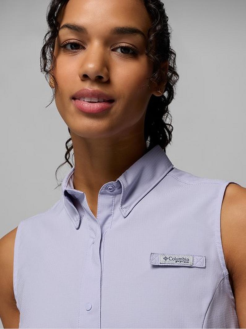 Woman wearing a light purple sleeveless button-up shirt with collar and chest pocket.