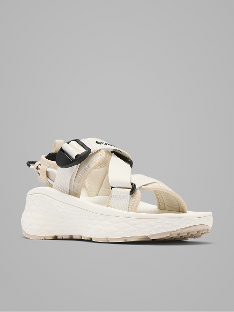 Platform sandal with cream and beige straps, black pull tabs, and chunky sole with textured tread.