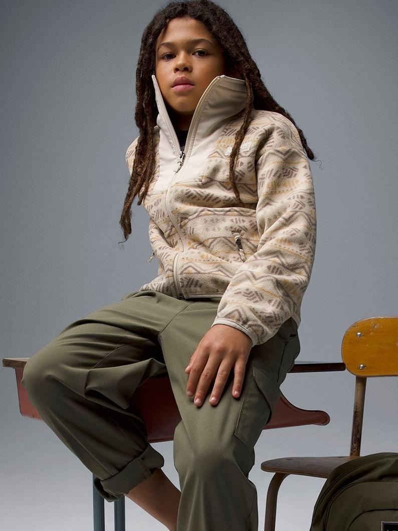 A boy wearing a beige fleece jacket.