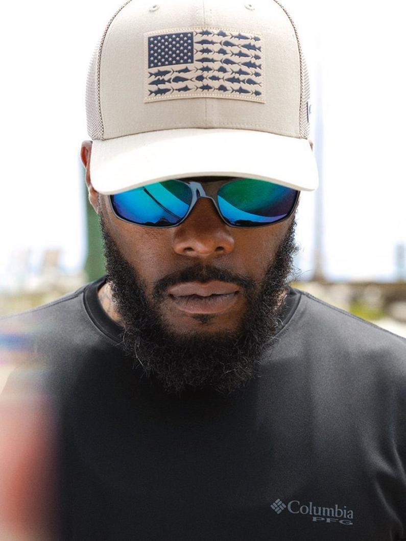 PFG Hat on a man wearing sunglasses and a black shirt.