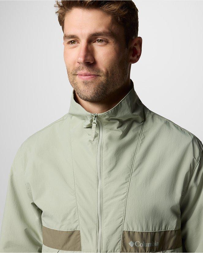 A man wearing a multi-color jacket.