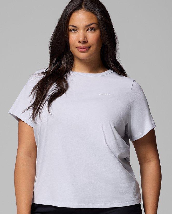 A woman wearing a white short-sleeve shirt.