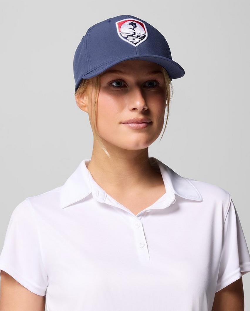 A woman wearing a blue PFG hat.