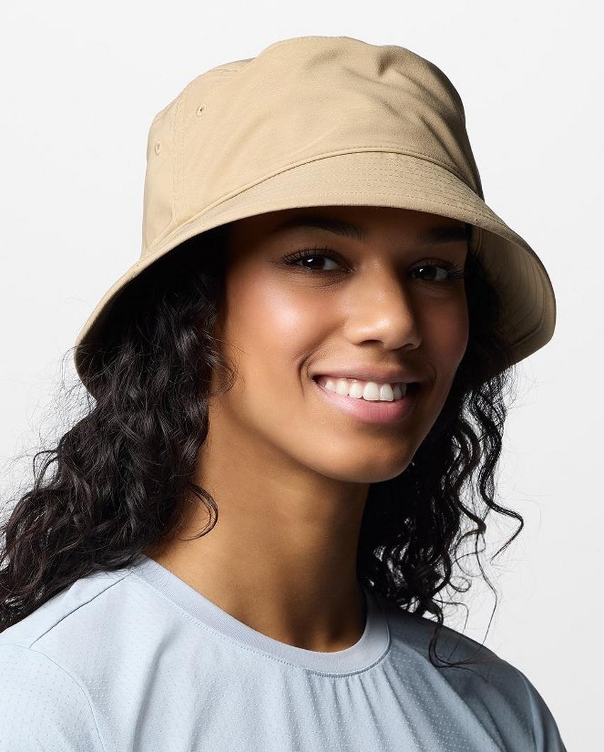 A woman wearing a tan bucket hat.