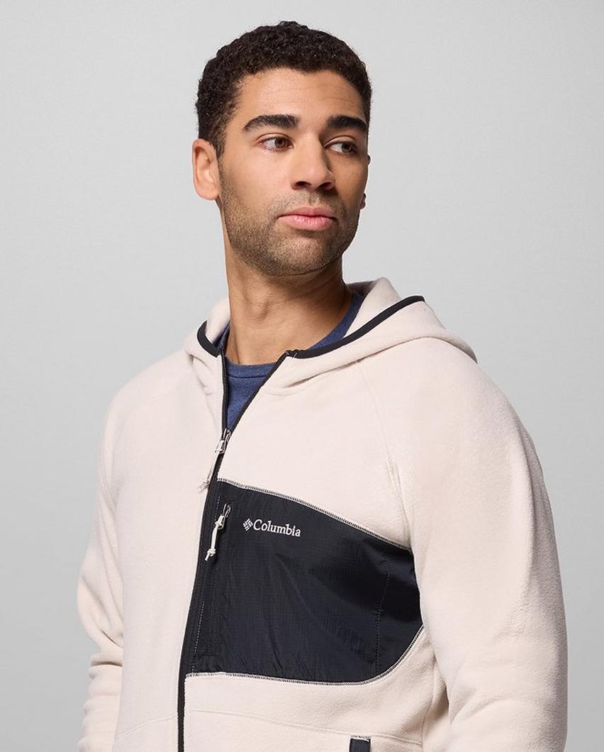 A man wearing a white fleece zip-up jacket.