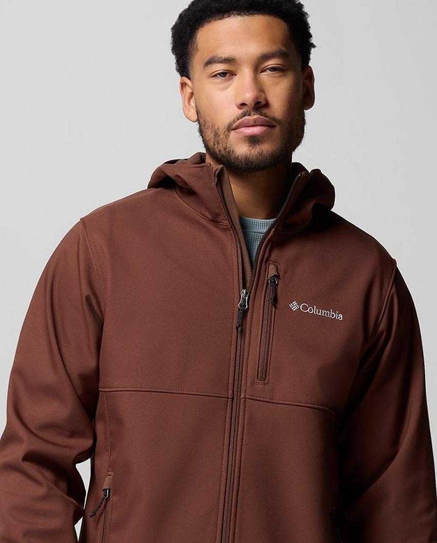 A man wearing a dark red softshell jacket.