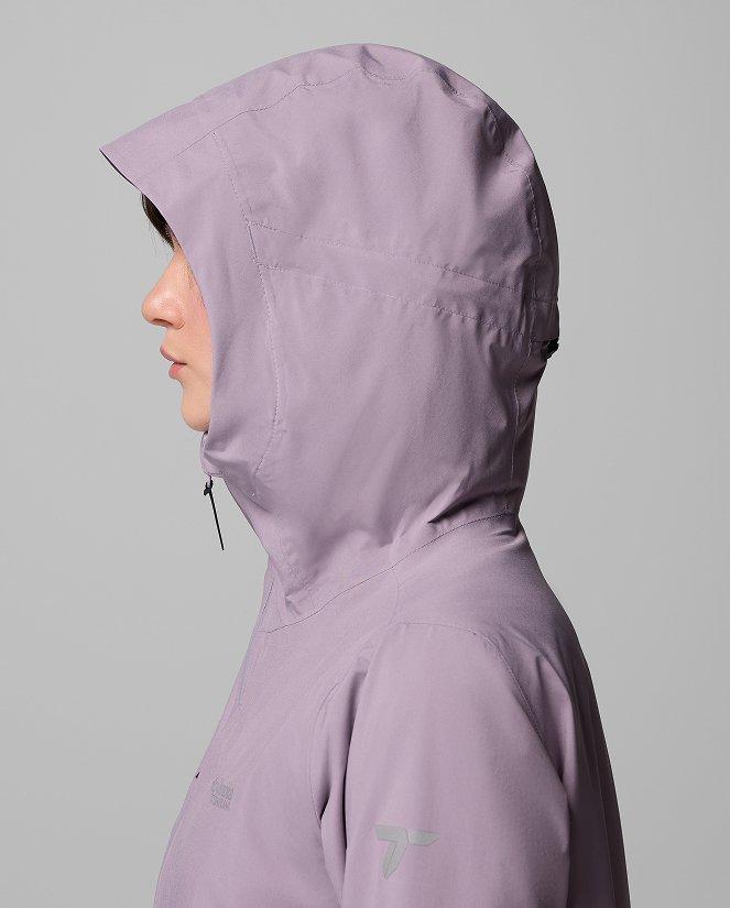 A woman wearing a purple rain jacket.
