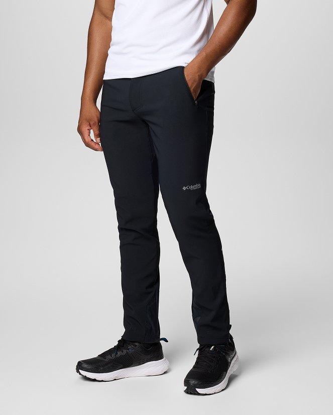 Waist-down image of a man wearing black pants and sneakers.