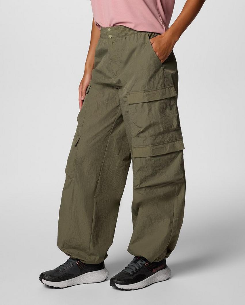 Waist-down image of a woman wearing relaxed cargo pants and sneakers.