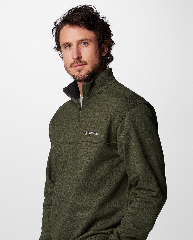 A man wearing a dark greeen pullover.