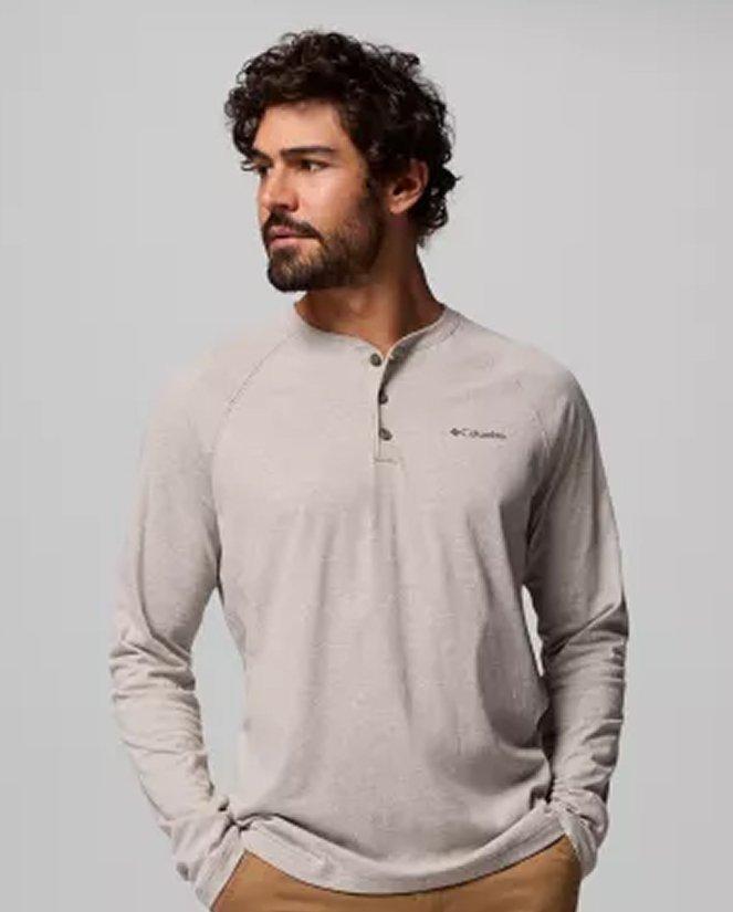 A man wearing a grey long-sleeve shirt.