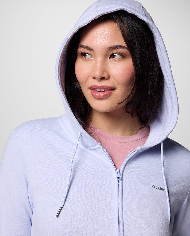 A woman wearing a light purple hoodie.