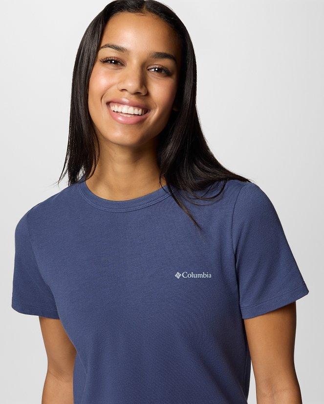 A woman wearing a blue short-sleeve shirt.