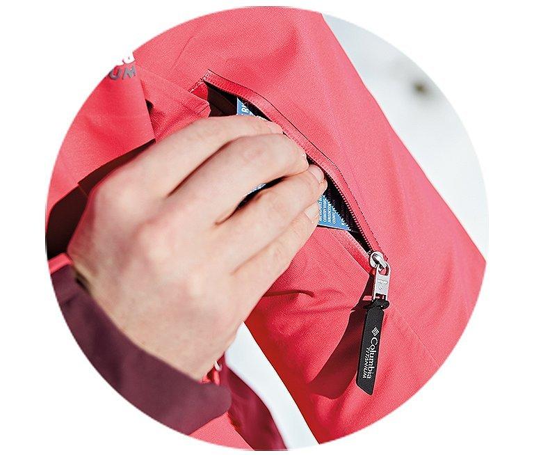 Someone sliding a card out of a sleek jacket pocket.