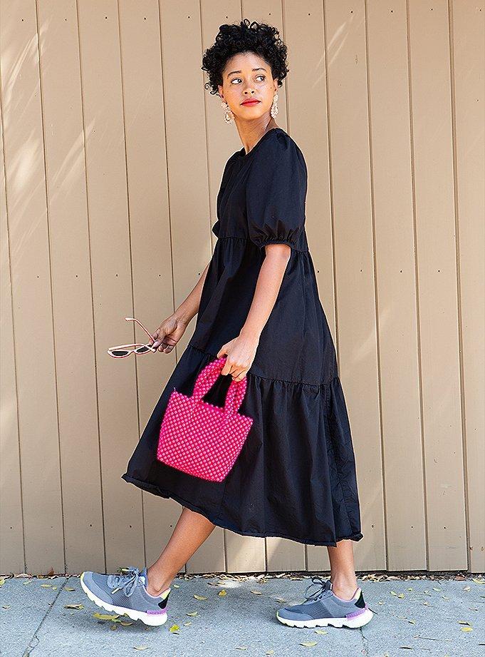 Candace Reels wearing Kinetic Lite Lace sneakers, walking in an urban setting