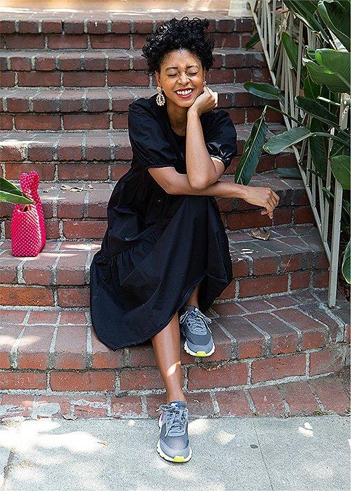 Candace Reels wearing Kinetic Lite Lace sneakers sitting on porch steps