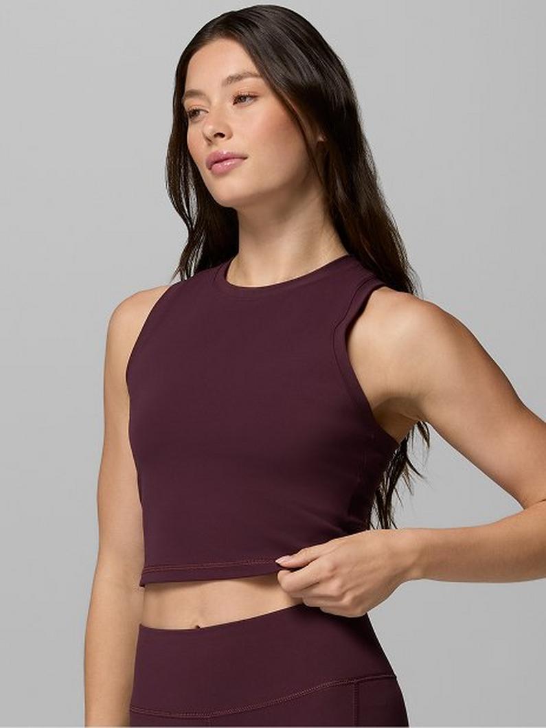 Woman wearing burgundy sleeveless crop top with matching high-waisted athletic bottoms.