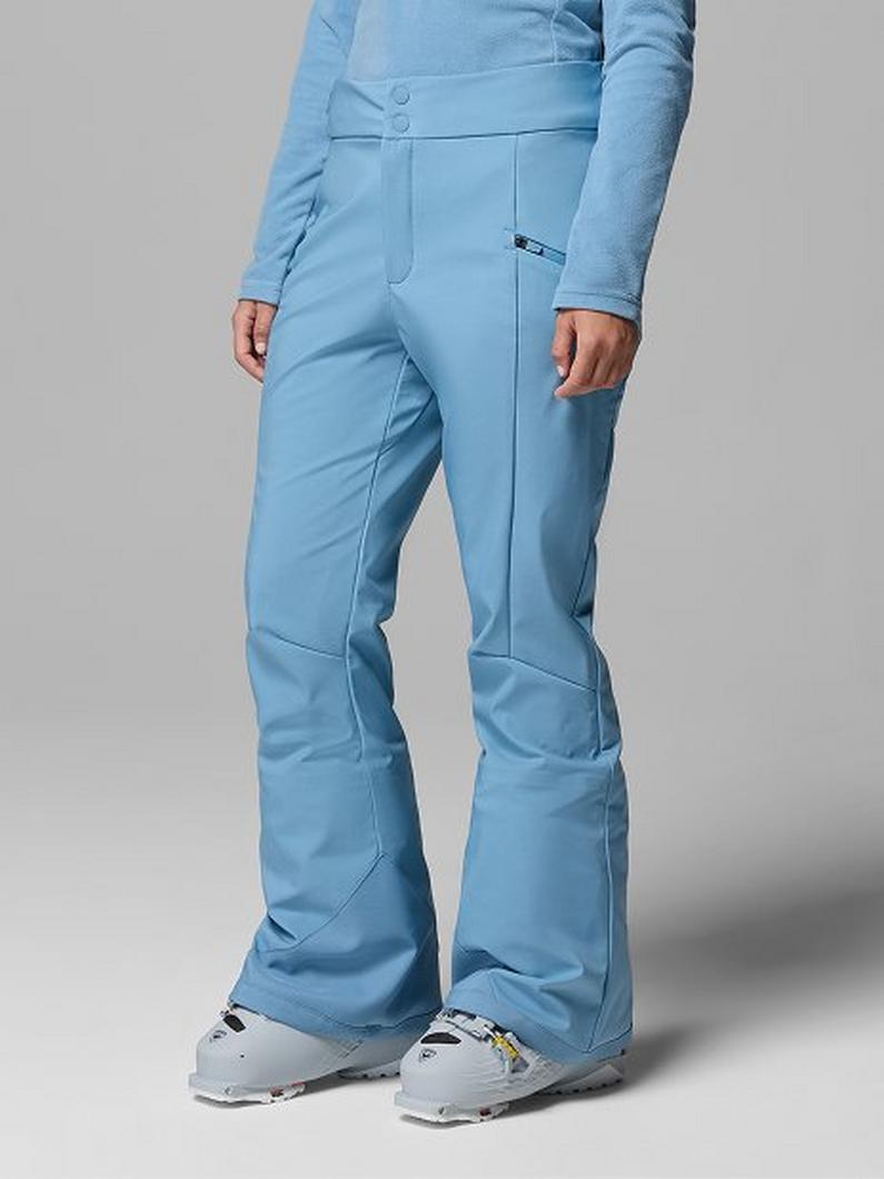 Light blue ski pants with zippered pocket worn with gray ski boots.