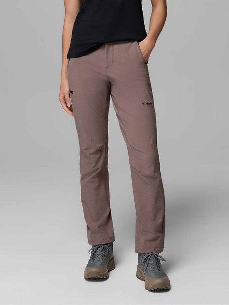 Person wearing taupe outdoor pants with cargo pocket and black top, paired with hiking shoes.