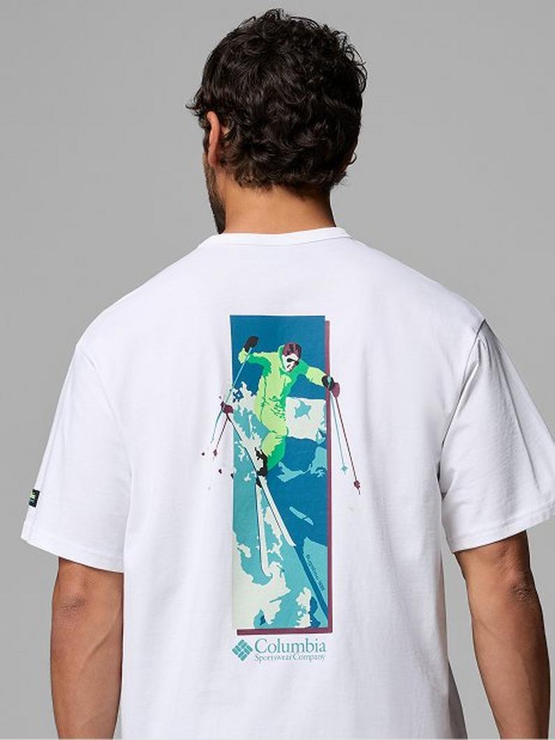 White t-shirt with back graphic showing skier in action on blue and green gradient panel.
