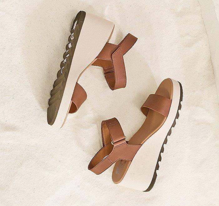 An Cameron Wedge sandals  on a beige background