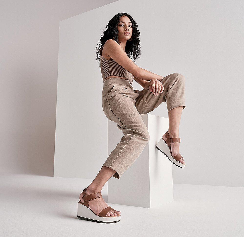 A woman wearing a Cameron Wedge sandal